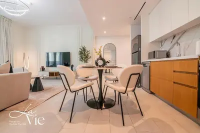 a kitchen and dining room with a table and chairs at La Vie, JBR - Exclusive Beach & Pool Access in Dubai