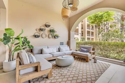 a living room with a couch and a table at DAYF-FMT Fairmont Palm with Pool and Beach Access in Dubai