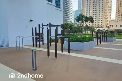 a park with a bunch of playground equipment in a city at Newly Furnished, Beach Access located in La Vie, JBR in Dubai