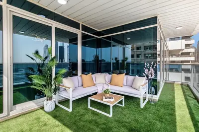 a patio with a couch and a table at Luxury 3BR Gem in the Heart of Dubai Marina in Dubai
