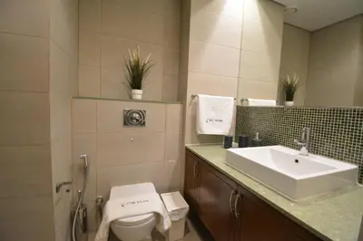 a bathroom with a toilet and a sink at Near to Nakheel Mall Swimming Pool and Sea View in Dubai