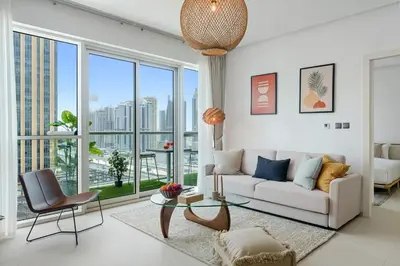 a living room with a couch and a glass table at DAYF-WST Stunning Marina Views at Marina Promenade in Dubai