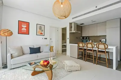 a living room with a couch and a table at DAYF-WST Stunning Marina Views at Marina Promenade in Dubai
