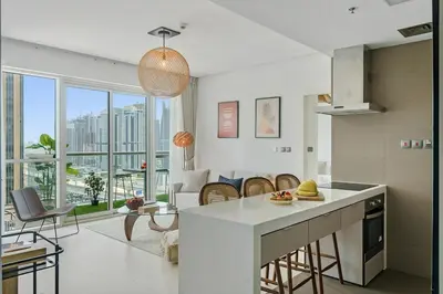 a kitchen and living room with a view of a city at DAYF-WST Stunning Marina Views at Marina Promenade in Dubai
