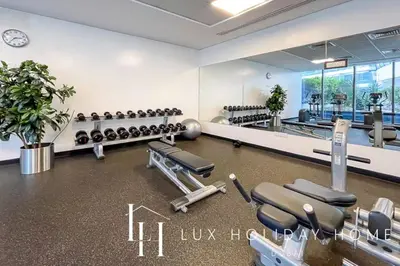 a gym with rows of exercise equipment in a room at LUX The Silverene Marina View Studio 2 in Dubai