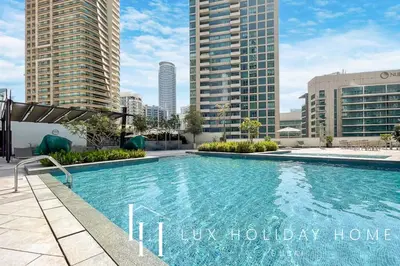 a swimming pool on the roof of a building with tall buildings at LUX The Silverene Marina View Studio 2 in Dubai