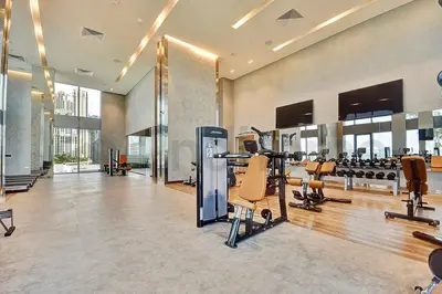 a gym with treadmills and exercise equipment in a building at Tourist Spot, Sea View - Next to Bluewaters & JBR in Dubai