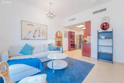 a living room with a couch and a table at Gardenia Bahar Suites 1 Bedroom Apartment in JBR with 2 mins walk to the Beach in Dubai