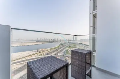 a balcony with two benches and a view of a highway at 1BR with Dubai Creek Views, Near Dubai Frame And Zabeel Park, Fawad Azizi Residence, Al Jadaf by Deluxe Holiday Homes in Dubai