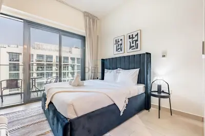 a bedroom with a large bed and a large window at Furnished Studio Near Meydan Racecourse, Minutes to Downtown Dubai, Azizi Riviera 47, Al Merkadh by Deluxe Holiday Homes in Dubai