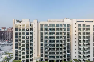two tall white buildings in a city at Furnished Studio Near Meydan Racecourse, Minutes to Downtown Dubai, Azizi Riviera 47, Al Merkadh by Deluxe Holiday Homes in Dubai