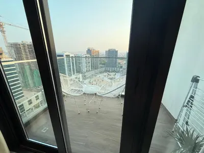 a balcony with chairs and a view of a city at Luxury Stay Dual View Furnished Swimming Pool Gym in Dubai