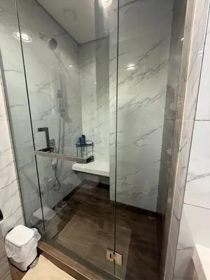 a bathroom with a shower with a toilet and a sink at Luxury Stay Dual View Furnished Swimming Pool Gym in Dubai