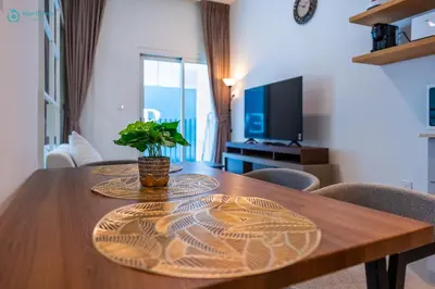 a wooden table with a potted plant on top of it at Blue Breeze - Modern 1BR, Dubai Hills, in Dubai