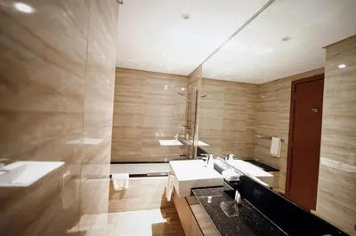 a bathroom with two sinks and a large mirror at Stylish and Charming 1BR in Urban Oasis by Missoni in Dubai