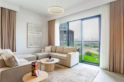 a living room with a couch and a table at NEW 2 Bed w Rooftop Pool Panoramic Dubai Views in Dubai