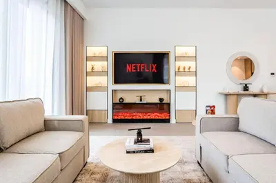 a living room with two couches and a tv at NEW 2 Bed w Rooftop Pool Panoramic Dubai Views in Dubai