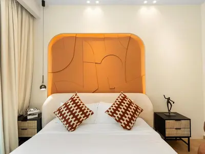 a bedroom with a bed with a large orange headboard at Luxury 2BR Apartment in Dubai Marina with Full Marina View in Dubai