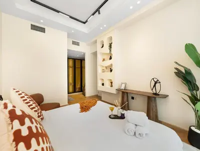 a bedroom with a white bed with towels on it at Luxury 2BR Apartment in Dubai Marina with Full Marina View in Dubai