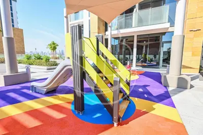 a playground in a building with a slide at Modern Cozy 1BR Retreat Azizi Riviera Dubai in Dubai