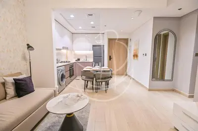 a living room with a couch and a table at Modern Cozy 1BR Retreat Azizi Riviera Dubai in Dubai
