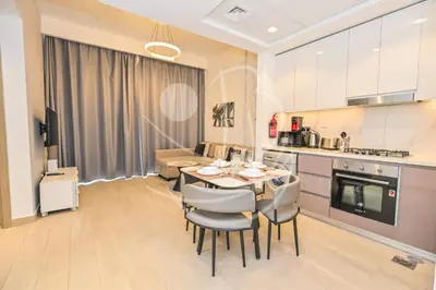 a kitchen and dining room with a table and chairs at Modern Cozy 1BR Retreat Azizi Riviera Dubai in Dubai