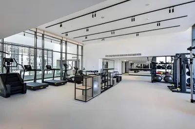 a gym with several treadmills and machines at Luxury Upgraded Studio in Wilton Park Residences in Dubai