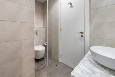 a white bathroom with a toilet and a sink at Luxury Penthouse - Scenic View - Near Burj Khalifa in Dubai
