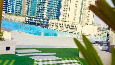 a view of a swimming pool in a city with tall buildings at Private jacuzzi Canal View Infinity Pool in Dubai