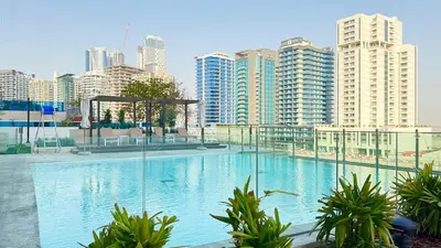 a large swimming pool in a city with tall buildings at Private jacuzzi Canal View Infinity Pool in Dubai