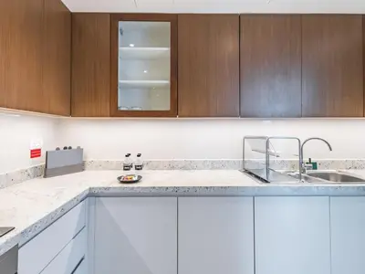 a kitchen with white cabinets and a sink at TRPS - BLVD Heights, Downtown Dubai - Luxury 1BR, Close to Dubai Mall in Dubai