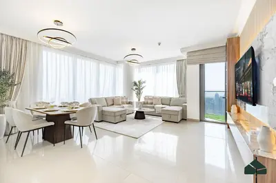a living room with a table and chairs at High Floor 2BR with Full Burj View by BMS in Dubai