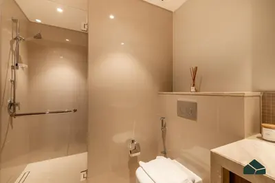 a bathroom with a shower and a toilet and a sink at High Floor 2BR with Full Burj View by BMS in Dubai
