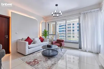 a living room with a couch and a table at bnbmehomes - 29 Boulevard Tower 1 in Dubai