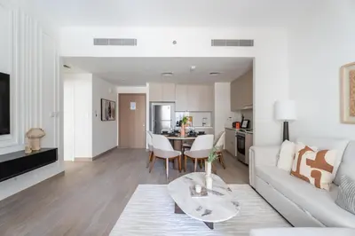 a living room with a white couch and a table at GuestReady - Tasteful home in Dubai Creek Harbour in Dubai