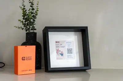 a picture frame sitting next to a vase with a plant at GuestReady - Tasteful home in Dubai Creek Harbour in Dubai