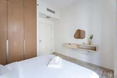 a bedroom with a white bed with a towel on it at GuestReady - Tasteful home in Dubai Creek Harbour in Dubai