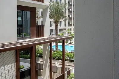 a view from the balcony of a building with a palm tree at GuestReady - Tasteful home in Dubai Creek Harbour in Dubai