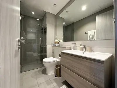 a bathroom with a toilet and a sink and a shower at Chic 1BR in Business Bay City Views & Upscale Comfort in Dubai