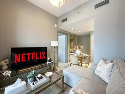 a living room with a couch and a tv at Chic 1BR in Business Bay City Views & Upscale Comfort in Dubai