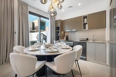 a kitchen and dining room with a table and chairs at Elegant 4BR Villa, Luxury Pool Retreat, Joy, Arabiana Ranches 3 in Sabkhah