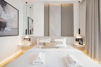 a bedroom with a large white bed with towels on it at Elegant 4BR Villa, Luxury Pool Retreat, Joy, Arabiana Ranches 3 in Sabkhah