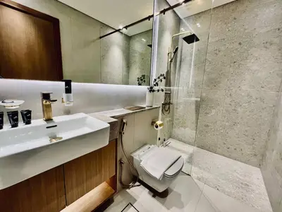 a bathroom with a toilet and a sink and a shower at Soft Modernity 1br Haven With Parking, Gym & Pool! in Dubai