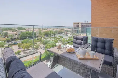 a table on a balcony with a view of a city at Frank Porter - Taraf 2 Residence in Dubai
