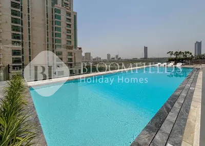 a swimming pool on the roof of a building at Bloomfields Cozy 1BR Binghatti Nova in Dubai