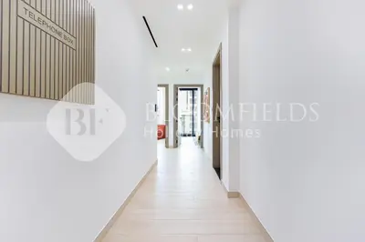 a corridor of an office building with white walls and a long hallway at Bloomfields Cozy 1BR Binghatti Nova in Dubai