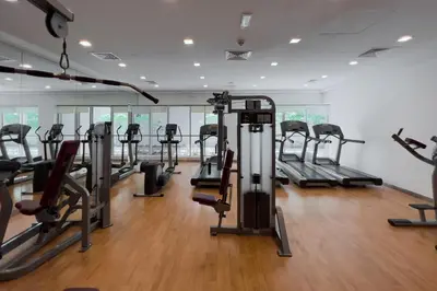 a gym with rows of treadmills and elliptical machines at New! 1BR with Balcony Views and Pool by Burj Khalifa in Dubai