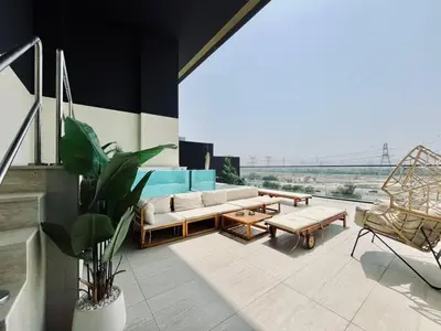 a living room with a couch and a view of a bridge at Sun Deck & Sleek Lap Pool Free Gym And Parking! in Dubai