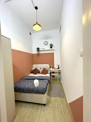 a small bedroom with a bed and a table at Duo Den Partiton Room In tecom Barsha Heights in Dubai