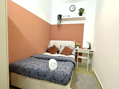 a small bedroom with a bed and a wall at Duo Den Partiton Room In tecom Barsha Heights in Dubai